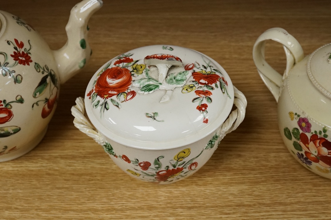 Two George III creamware teapots and a lidded sugar bowl, c.1780, largest 20cm wide